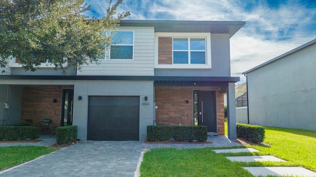 view of front facade with a garage and a front lawn