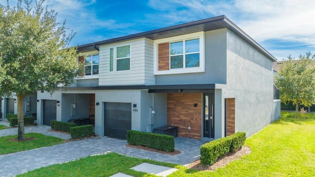 view of front of home featuring a garage and a front lawn