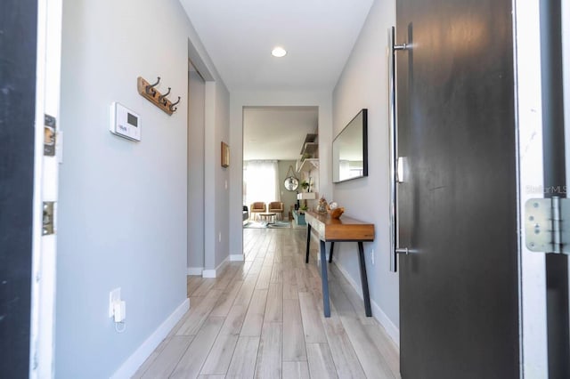 hallway with light hardwood / wood-style flooring