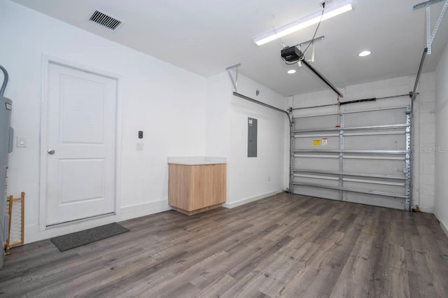 garage with electric panel and a garage door opener