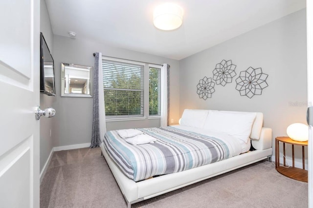 bedroom featuring light carpet