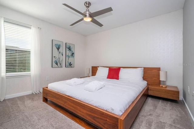 bedroom with ceiling fan and light carpet