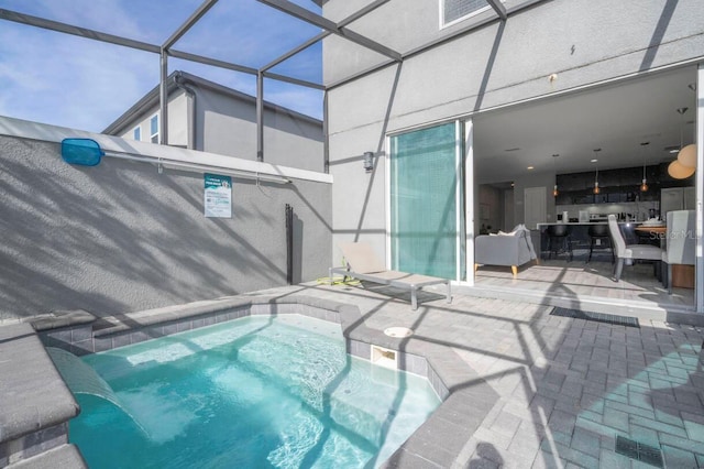 view of swimming pool featuring a patio and a lanai