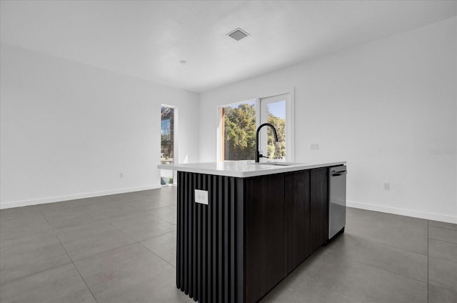 kitchen featuring a center island with sink, stainless steel dishwasher, and sink