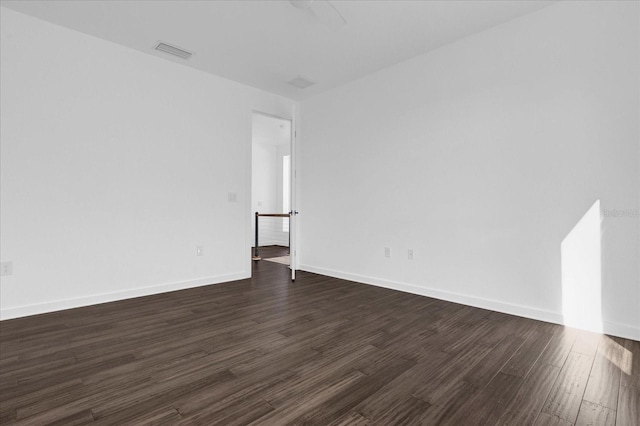 empty room with dark hardwood / wood-style floors