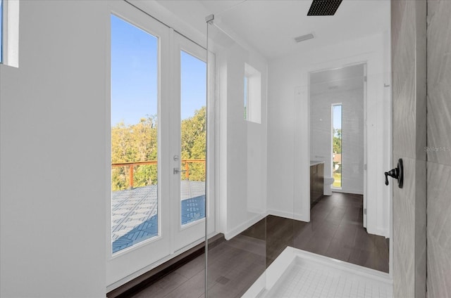 doorway to outside with dark hardwood / wood-style flooring and plenty of natural light