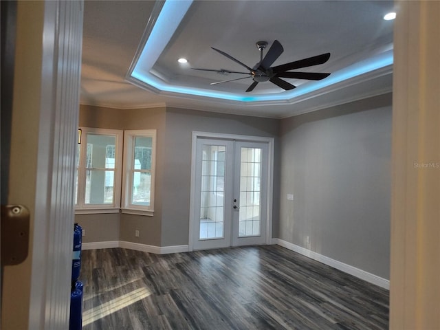 unfurnished room with french doors, crown molding, dark hardwood / wood-style floors, ceiling fan, and a tray ceiling