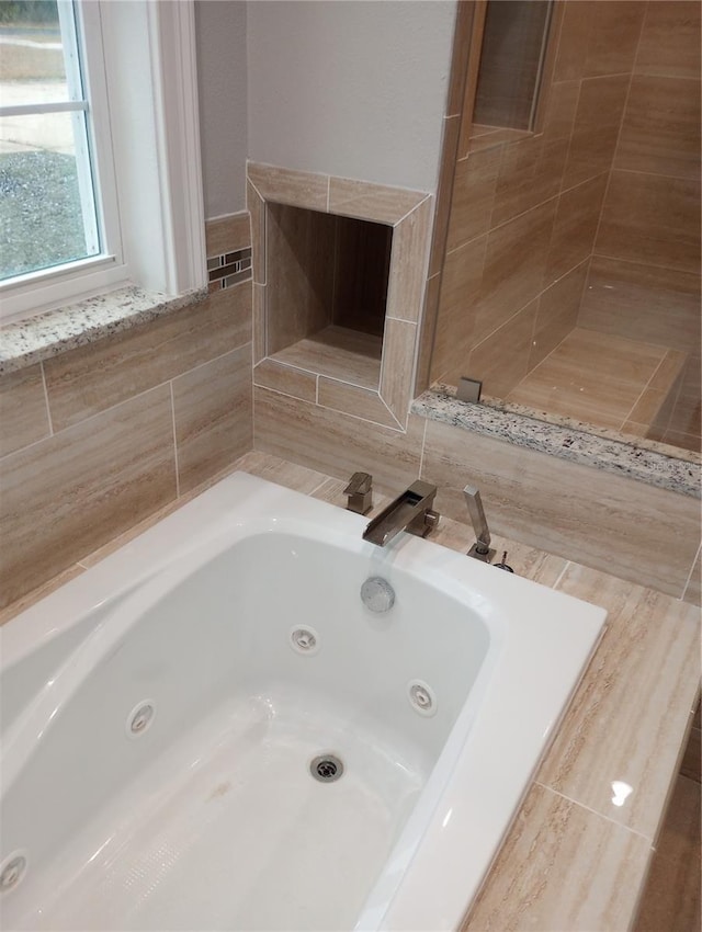 bathroom with tiled tub