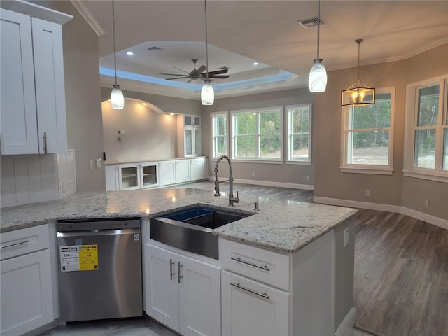 kitchen featuring dishwasher, sink, a tray ceiling, white cabinets, and ceiling fan with notable chandelier