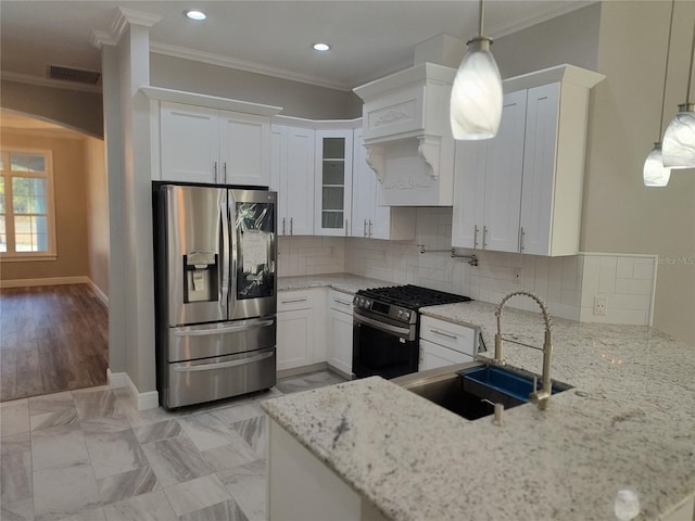 kitchen with black range with gas stovetop, stainless steel fridge with ice dispenser, white cabinets, and hanging light fixtures