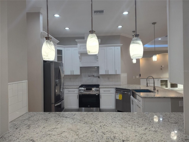 kitchen with white cabinetry, sink, hanging light fixtures, and appliances with stainless steel finishes