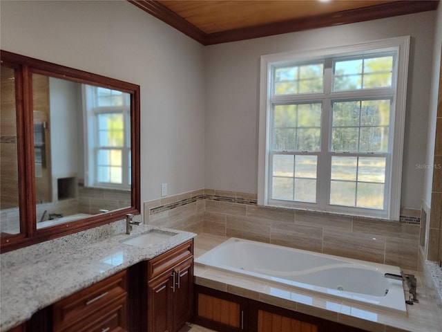 bathroom featuring vanity, crown molding, and tiled bath