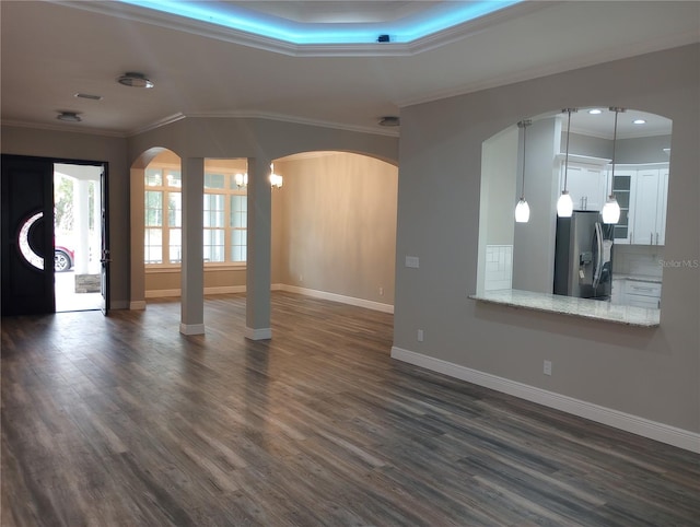 unfurnished living room with dark wood-type flooring and crown molding