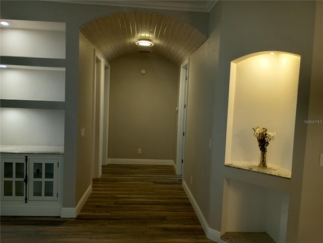 corridor with built in shelves and dark hardwood / wood-style flooring