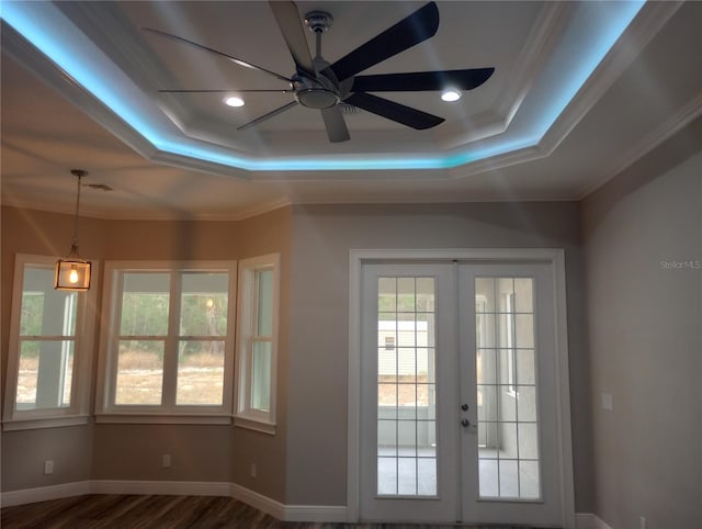 doorway to outside with french doors, dark wood-type flooring, a raised ceiling, and crown molding