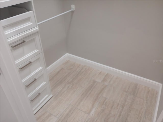 walk in closet featuring light wood-type flooring