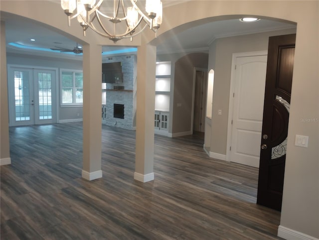 interior space with french doors, a fireplace, dark hardwood / wood-style flooring, and ceiling fan with notable chandelier