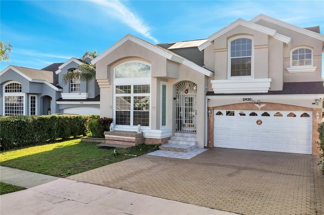 view of front facade with a front yard and a garage