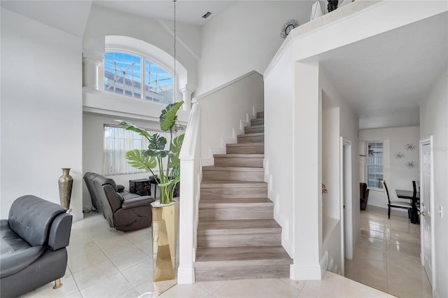 staircase featuring tile patterned flooring