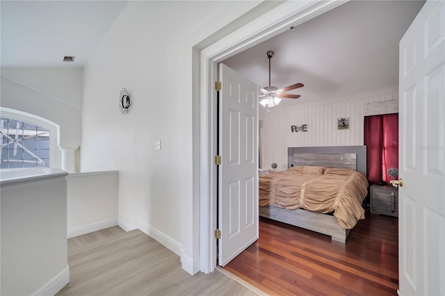 bedroom featuring ceiling fan, wood-type flooring, and lofted ceiling