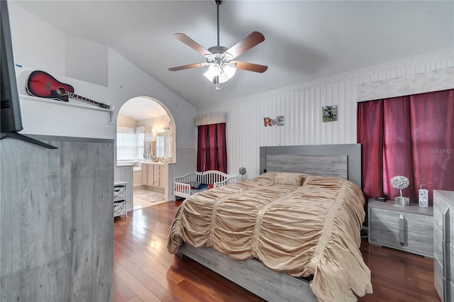 bedroom with ensuite bath, dark hardwood / wood-style floors, vaulted ceiling, and ceiling fan