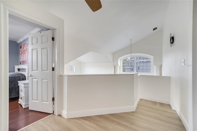 corridor featuring hardwood / wood-style flooring and lofted ceiling