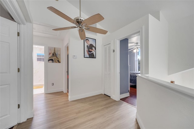 corridor with light hardwood / wood-style floors