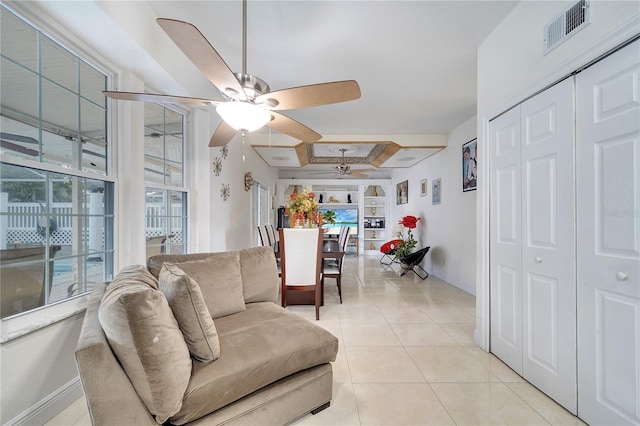 living room with ceiling fan and light tile patterned floors