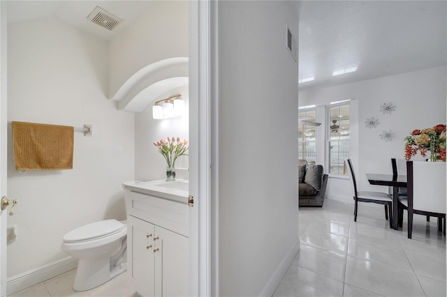 bathroom featuring tile patterned flooring, vanity, and toilet