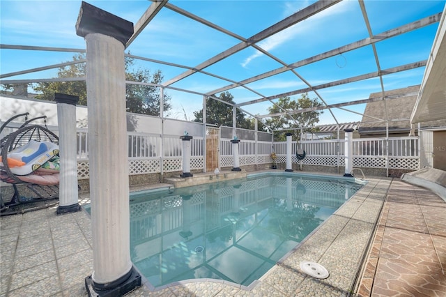 view of swimming pool featuring a lanai and a patio area