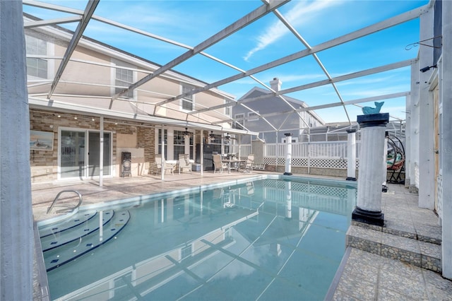 view of pool with a patio and a lanai