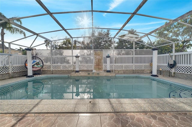 view of swimming pool with glass enclosure