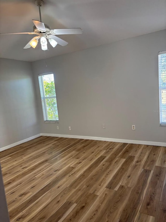 spare room featuring ceiling fan and dark hardwood / wood-style flooring