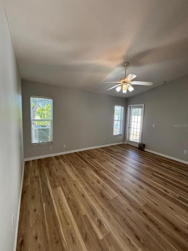 spare room featuring wood-type flooring and ceiling fan