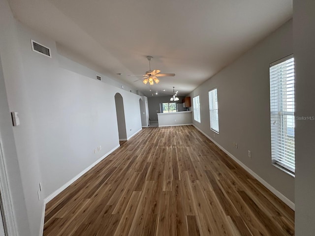 unfurnished living room featuring ceiling fan and dark hardwood / wood-style floors