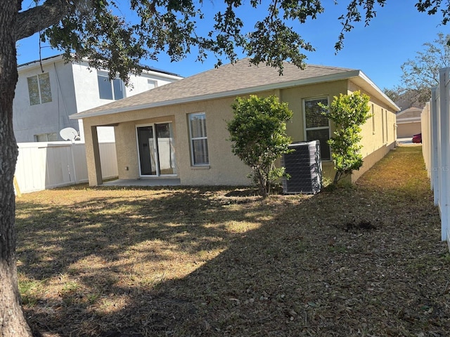 rear view of property featuring cooling unit and a patio area