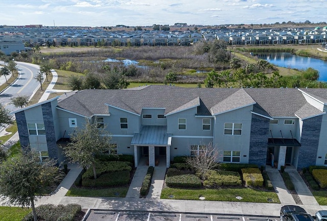 birds eye view of property with a water view