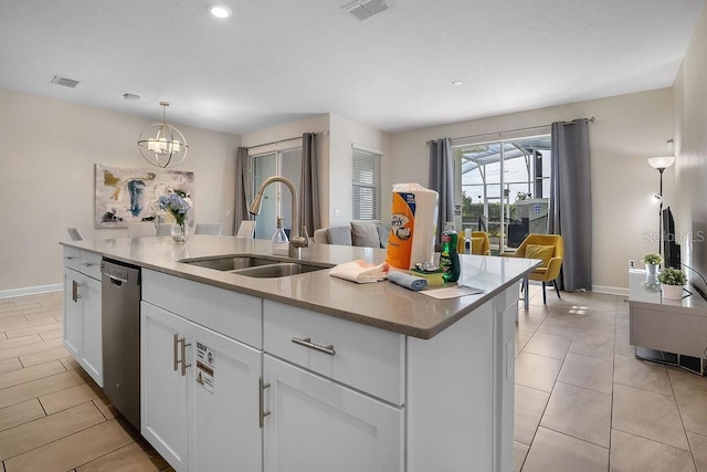 kitchen featuring sink, white cabinetry, decorative light fixtures, dishwasher, and an island with sink