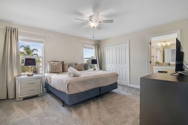 bedroom with light colored carpet, a closet, and ceiling fan