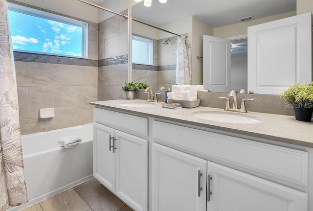 bathroom with shower / tub combo with curtain, vanity, and tile patterned flooring