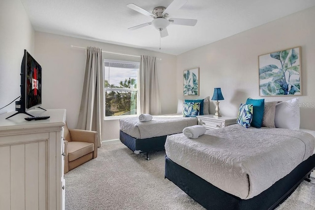 bedroom featuring light carpet and ceiling fan