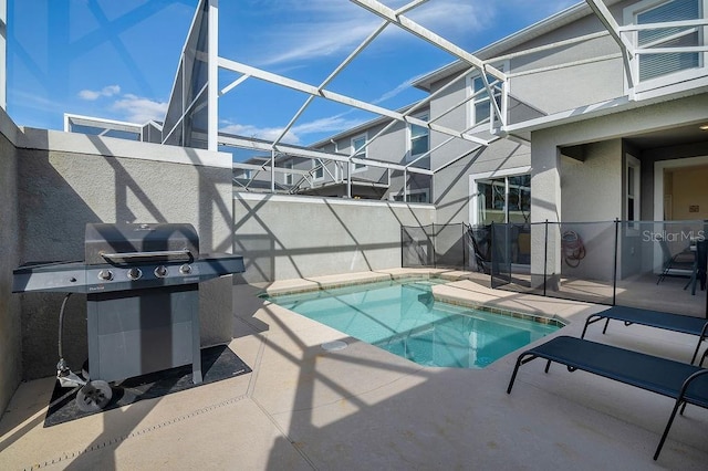 view of swimming pool featuring a grill, a patio, and glass enclosure