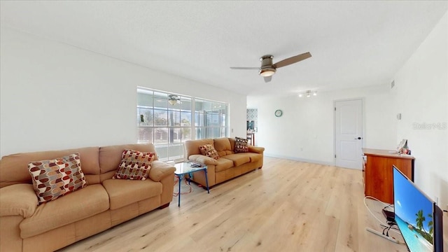 living room with ceiling fan and light wood-type flooring