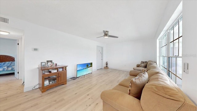 living room featuring ceiling fan and light hardwood / wood-style floors