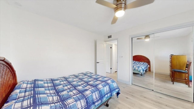 bedroom featuring ceiling fan, a closet, and light hardwood / wood-style flooring