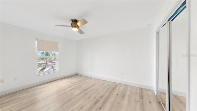 unfurnished bedroom with ceiling fan, a closet, and light hardwood / wood-style flooring