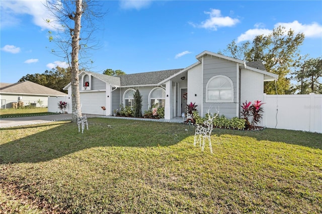 ranch-style home with a garage and a front lawn