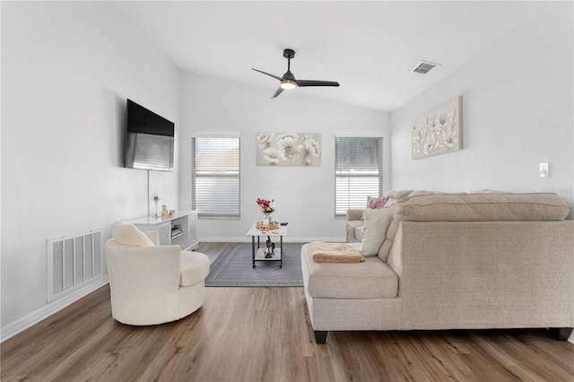 living room with ceiling fan, wood-type flooring, and vaulted ceiling