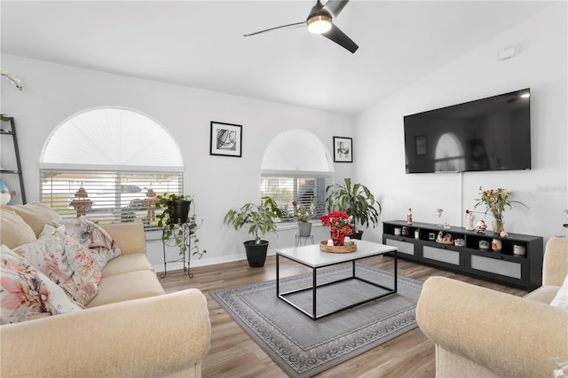 living room featuring ceiling fan, light hardwood / wood-style flooring, and lofted ceiling