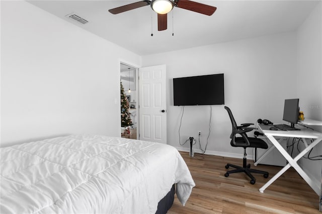 bedroom featuring hardwood / wood-style flooring and ceiling fan